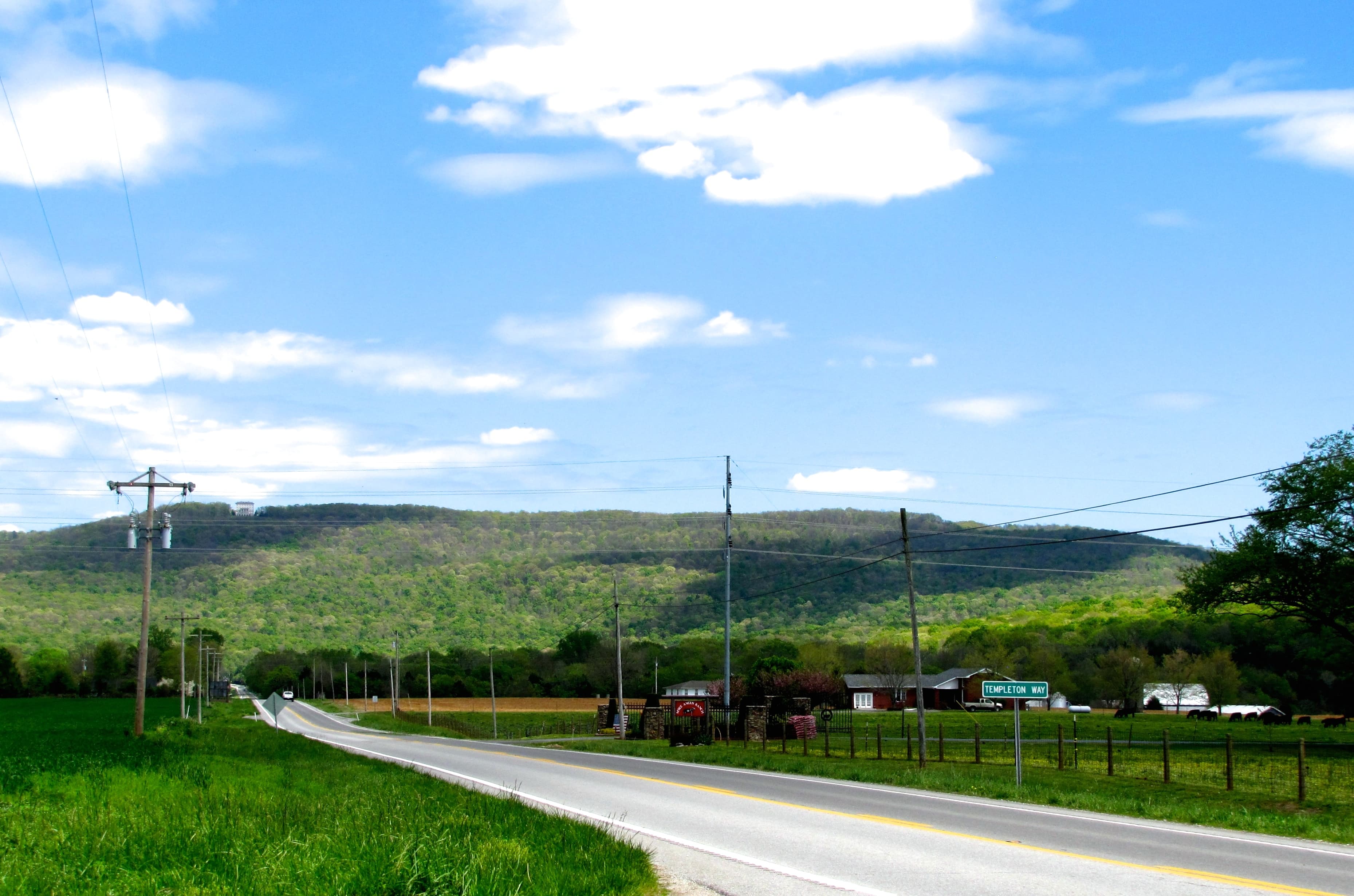 State highway approaching the Cumberland Plateau in Tennessee, showing the dramatic escarpment and forested ridge